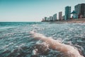 Beautiful scenery of the sea waves splashing on the beach in Ondas with buildings in the background Royalty Free Stock Photo