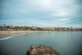 Beautiful scenery of seawater, beach on the other side and mountains, houses under a blue sunny sky Royalty Free Stock Photo