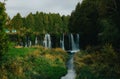 Beautiful scenery of series of waterfalls cascading in tropical park with lush vegetation Royalty Free Stock Photo