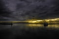 Beautiful scenery of a ship on the sea with the breathtaking fire-like storm clouds in background