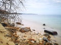 The beautiful silky smooth water waves and rocks on the sea shore. Royalty Free Stock Photo