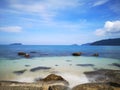 The beautiful silky smooth water waves and rocks on the sea shore. Royalty Free Stock Photo