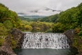 Beautiful scenery of small dam with waterfalls in early autumn season at Yamabikotsuri Bridge.