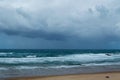 Beautiful scenery of splashing sea waves under a cloudy sky Royalty Free Stock Photo