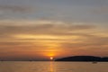 Beautiful scenery sunset with glowing orange light painted on cloudy sky become to twilight dawn, above the sea, long tail boat Royalty Free Stock Photo