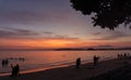 Beautiful scenery sunset with glowing orange light painted on cloudy sky become to twilight dawn, above the sea, long tail boat Royalty Free Stock Photo