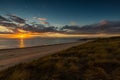 Beautiful scenery of the sunset reflecting in the ocean in Vlissingen, Zeeland, Netherlands