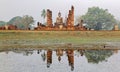 Beautiful scenery of Wat Mahathat Temple in Sukhothai Historical Park, Thailand, with view of a Buddha statue seated Royalty Free Stock Photo