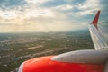 Beautiful scenic city view of sunset through the aircraft window..Airplane interior with window view of blue sky and wing..Looking Royalty Free Stock Photo