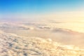 Beautiful scenic dramatic morning sunrise cloudscape aerial view from plane window. Gradient colored fluffy clouds during aircraft