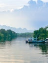 Beautiful scenic of fishing boat at pier with riverview in evening. Commercial fishing vessels docked at fish village. Wooden Royalty Free Stock Photo