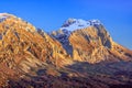 Beautiful scenic golden autumn landscape of Fisht mountain peak at sunset under blue sky, West Caucasus, Russia