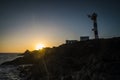 Beautiful scenic landscape with classic lighthouse and golden sunset in background - concept of travel and scenic place. for Royalty Free Stock Photo