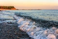 Beautiful scenic landscape of stony beach at rocky Black Sea coast. Wave breaking on seashore. Summer sunset at Caucasus mountain Royalty Free Stock Photo