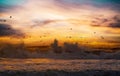 Beautiful scenic ocean beach landscape, orange evening sky clouds, flock of birds, heavy breaking surf waves, sea spray foam  - Royalty Free Stock Photo