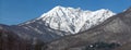 Beautiful scenic panoramic winter landscape of snow covered Caucasus mountain peaks on sunny day with clear blue sky. Achishkho Royalty Free Stock Photo