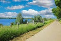 Beautiful scenic rural dutch landscape , river Maas lake, cycle track, green trees, blue sky - Ohe en Laak, Netherlands