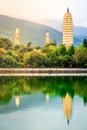 Beautiful scenic vertical view of Dali Three Pagodas of Chongsheng Temple with water reflection and dramatic light Dali Yunnan