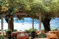 Beautiful scenic view on cozy restaurant in Bellagio on Lake Como, lombardy, North Italy with water of Como, small boat and Alps Royalty Free Stock Photo