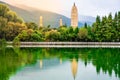 Beautiful scenic view of Dali Three Pagodas of Chongsheng Temple with water reflection and dramatic light Dali Yunnan China