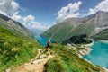 Beautiful scenic view of high mountain lakes.Girl hiking to the Mooserboden dam in Austrian Alps.Active sporty lifestyle.Wonderful