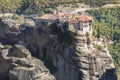 Beautiful scenic view, Orthodox Monastery of Varlaam, immense monolithic pillar, green foliage at the background of stone wall in