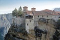 Orthodox Monastery of Varlaam, immense monolithic pillar, green foliage at the background of stone wall in