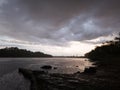 A beautiful scenic view of the Sava River against dramatic ominous storm clouds during heavy rain on a rainy stormy day and an oil