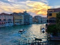 A beautiful scenic view of a single water taxi boating down the grand canal as the sun sets Royalty Free Stock Photo