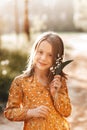 Beautiful school-age girl with lily of the valley flowers in her hand. Summer, sunset Royalty Free Stock Photo