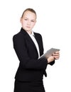 Beautiful school girl in a business suit holds a pc tablet in his hands and looking into the camera Royalty Free Stock Photo