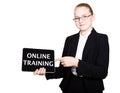 Beautiful school girl in a business suit holds a pc tablet in his hands and looking into the camera, on a pc tablet Royalty Free Stock Photo