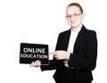 Beautiful school girl in a business suit holds a pc tablet in his hands and looking into the camera, on a pc tablet Royalty Free Stock Photo