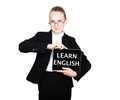 Beautiful school girl in a business suit holds a pc tablet in his hands and looking into the camera, on a pc tablet Royalty Free Stock Photo