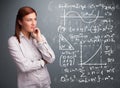 Beautiful school girl thinking about complex mathematical signs Royalty Free Stock Photo