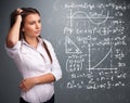 Beautiful school girl thinking about complex mathematical signs Royalty Free Stock Photo