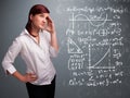 Beautiful school girl thinking about complex mathematical signs Royalty Free Stock Photo