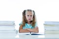 Frustrated little schoolgirl feeling a failure unable to concentrate in reading and writing difficulties learning problem