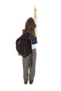 Beautiful schoolgirl with backpacks pointing at wall. Back view