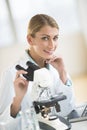 Beautiful Scientist Sitting With Microscope At Desk Royalty Free Stock Photo