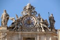 Beautiful sculptures and the clock at the roof of St. Peter`s Basilica in the Vatican CIty Royalty Free Stock Photo