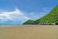 Beautiful sea beach and a forest trees mountain with blue cloud sky