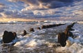 Beautiful sea landscape, storm on the Baltic Sea, cloudy sky, waves break over the breakwaters.