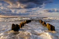 Beautiful sea landscape, storm on the Baltic Sea, cloudy sky, waves break over the breakwaters.