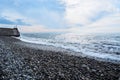 Beautiful sea landscape. Strong powerful sea waves break on shingle sea shore. Dangerous power of element of water