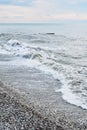 Beautiful sea landscape. Strong powerful sea waves break on shingle sea shore. Dangerous power of element of water