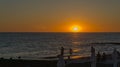 Beautiful sea landscape with sunset on the horizon. Sochi, Black Sea coast of south of Russia. People are resting on the seashore