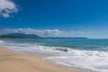 Beautiful sea beach, sand, waves, white foam, blue sky, white clouds. Royalty Free Stock Photo