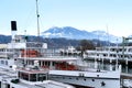 Beautiful sea, river landscape with boats, pier in Lucerne, Switzerland, white expensive yachts on lake, snow-covered mountains in Royalty Free Stock Photo