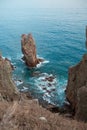 Beautiful sea and rocks looking from top of the clift. Various form of sea foam wave from arial view. Evening light